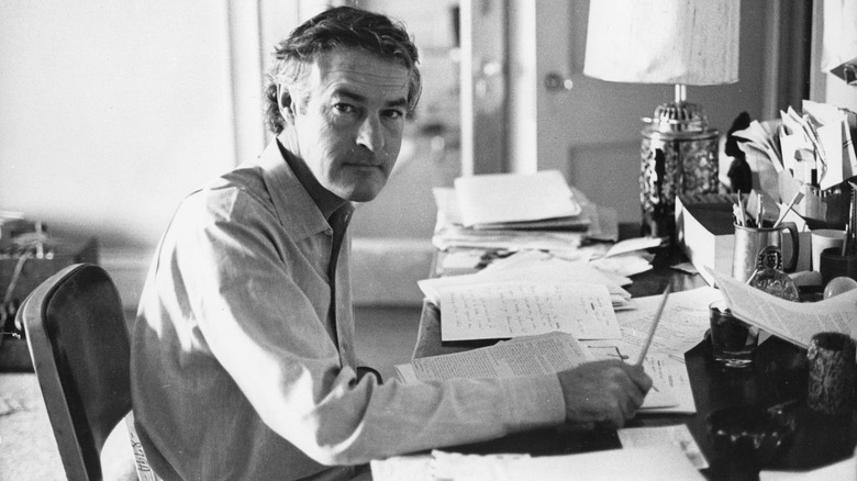 Timothy Leary sitting at his desk