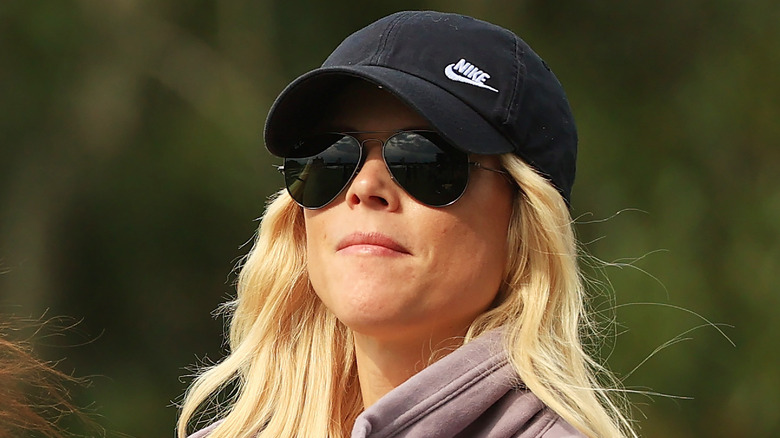 Elin Nordegren wearing sunglasses and cap