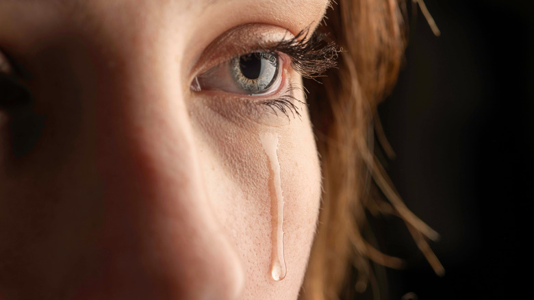 Woman with tear falling 