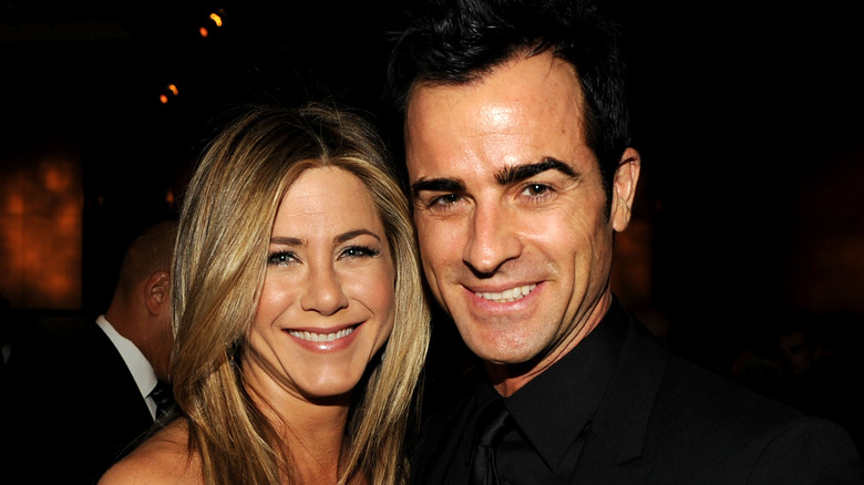 Jennifer Aniston and Justin Theroux smile for the camera.