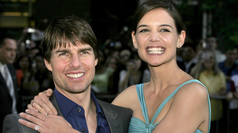 Katie Holmes and Tom Cruise smiling at an event