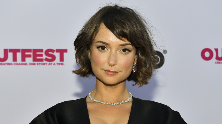 Milana Vayntrub posing on a red carpet