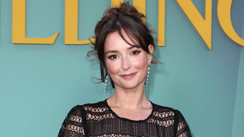 Milana Vayntrub posing on a red carpet