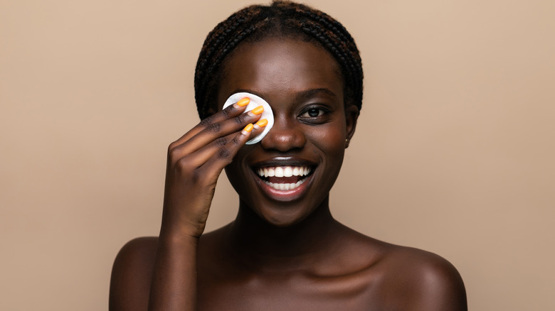 smiling woman removing makeup