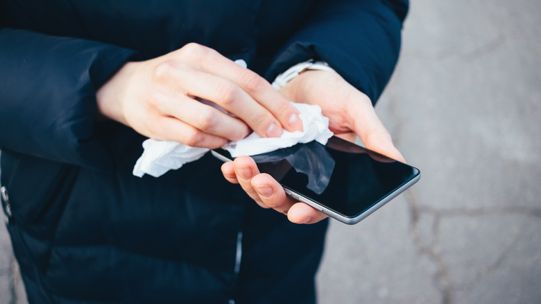 Woman cleaning her phone