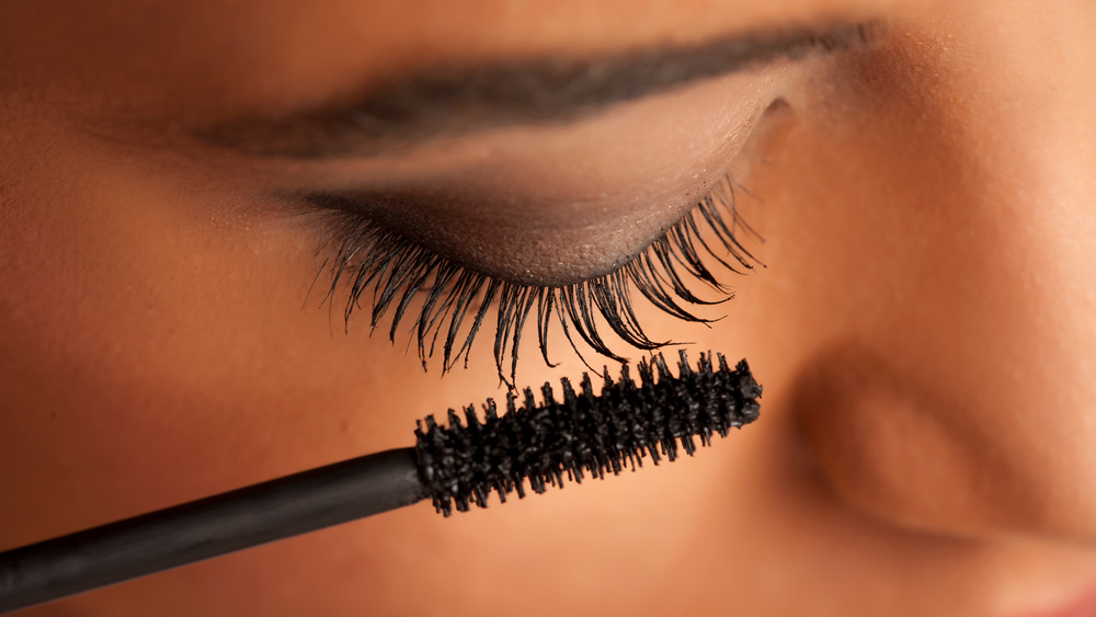 Woman applying mascara