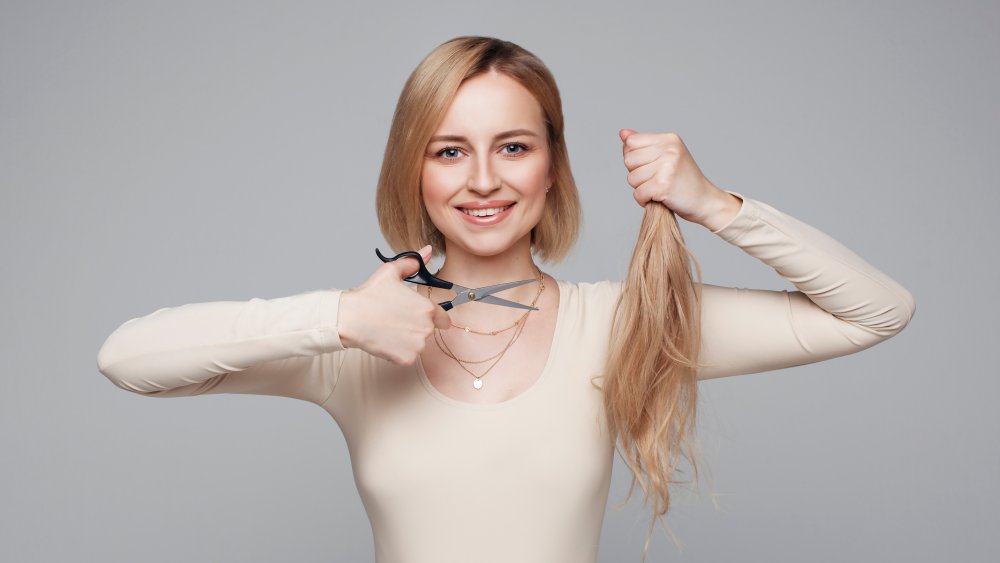 Woman cutting her own hair