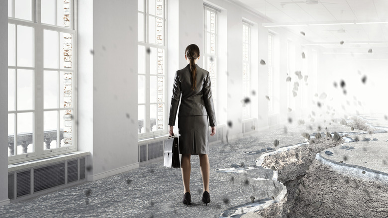 woman in empty earthquake-damaged office