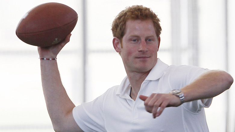 Prince Harry preparing to throw an American football