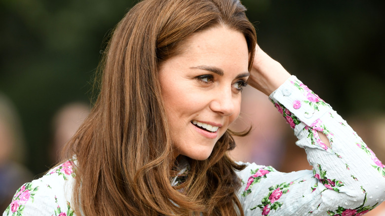 Kate Middleton puts hand to head