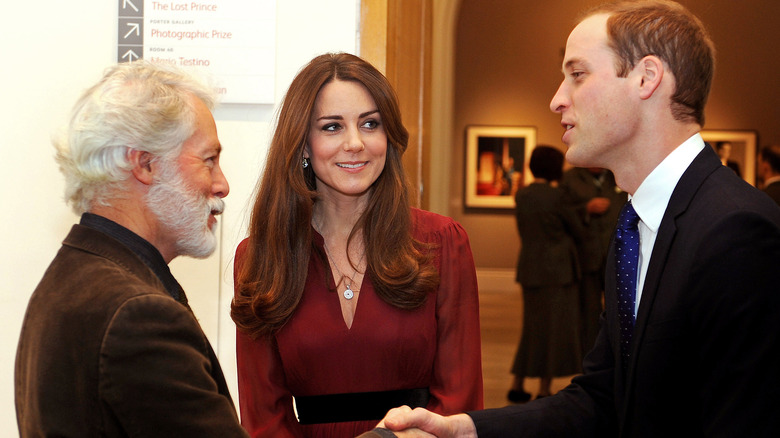 Paul Emsley shakes hands with Prince William, Kate Middleton stands between