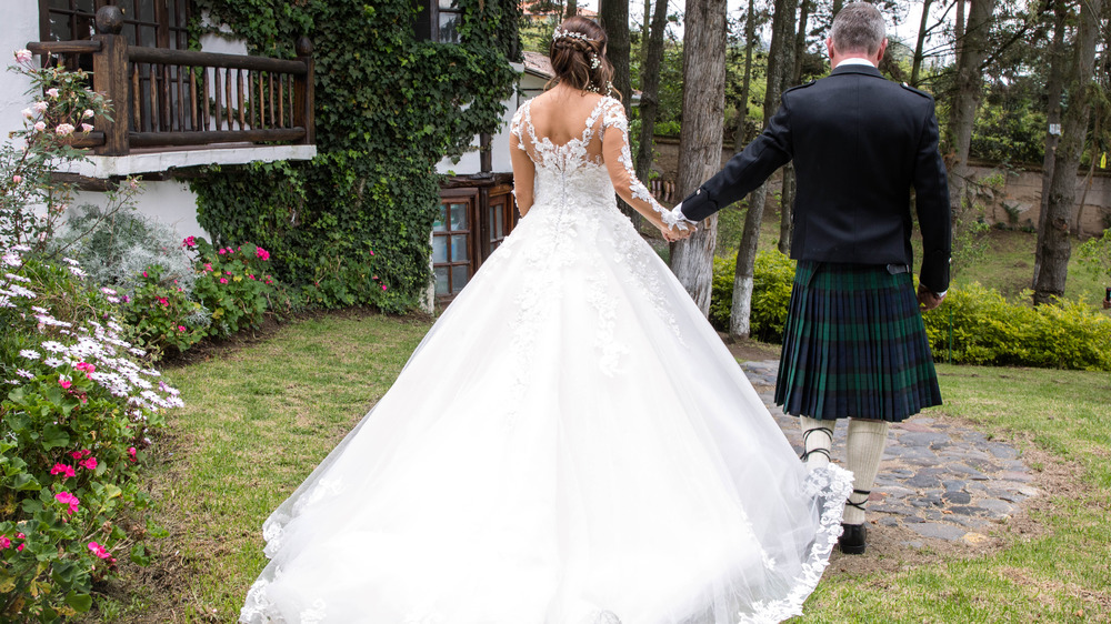 Scottish bride and groom from behind