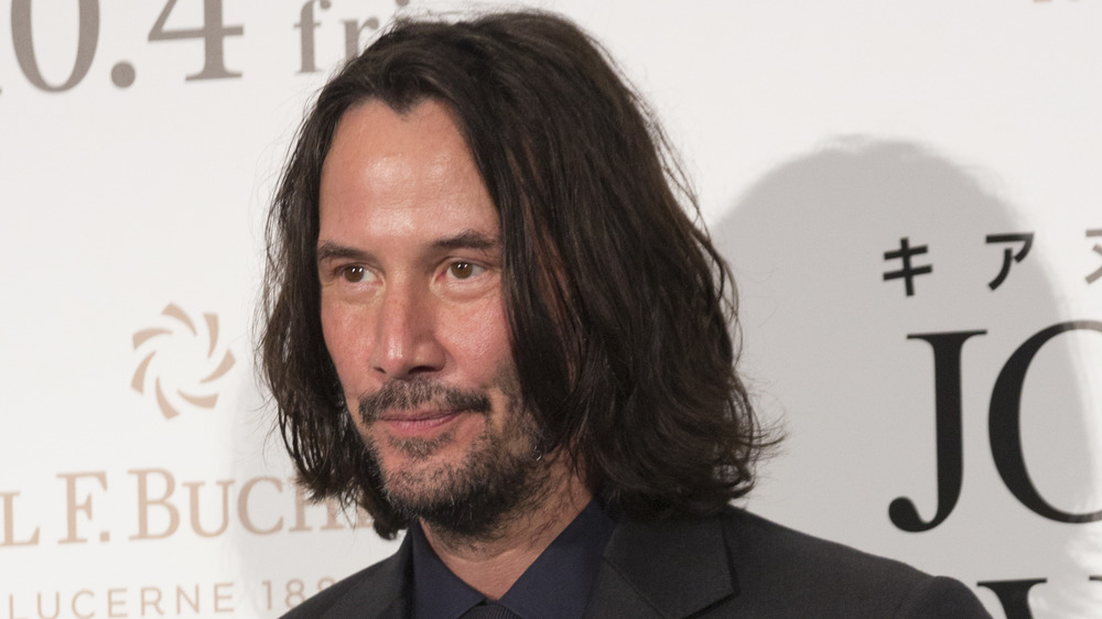 Keanu Reeves with a small smile