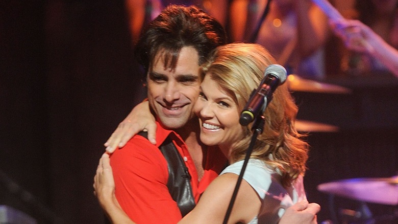 John Stamos and Lori Loughlin hug onstage