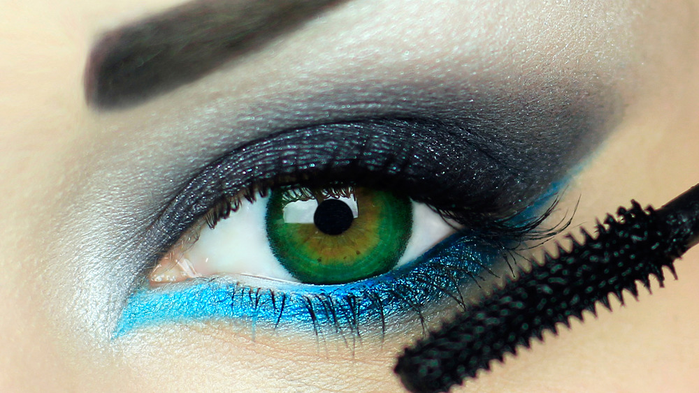 A woman's eye with blue and black eyeshadow