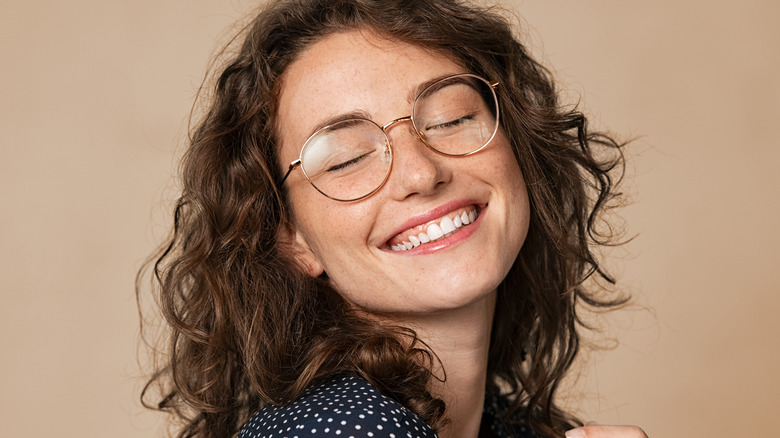 Woman with curly brunette hair smiling