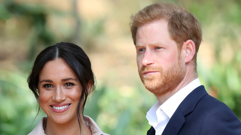 Meghan and Harry smile for photographers