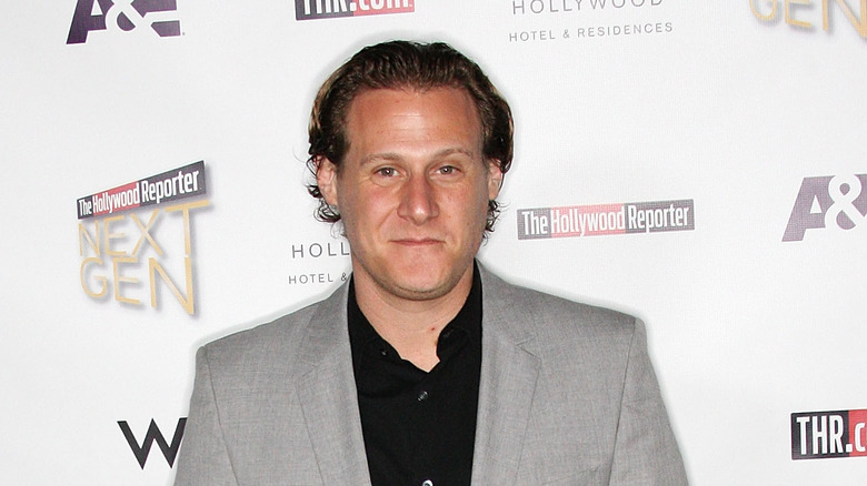 Trevor Engelson wearing a gray suit