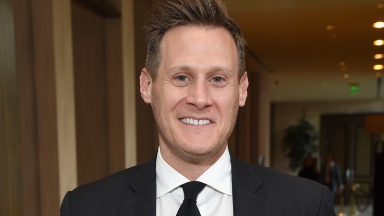 Trevor Engelson smiling in a suit 