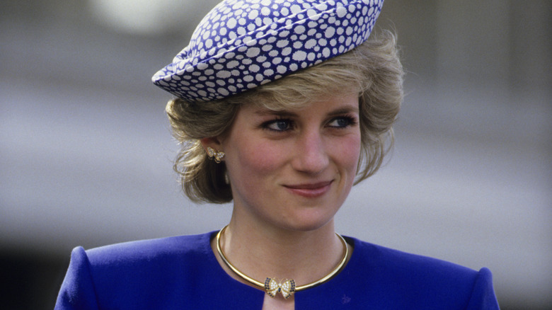 Princess Diana grinning and looking off to the side 