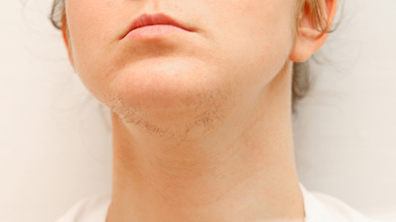 Woman's chin with hair