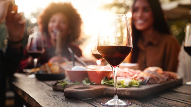 friends at dinner with glasses of wine on the table