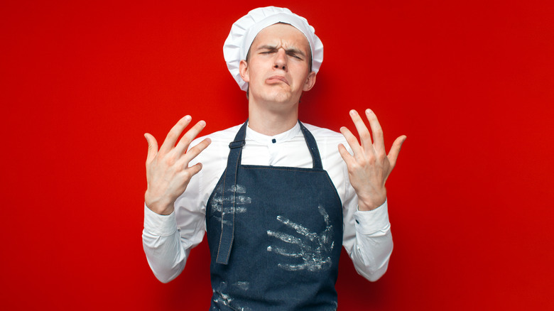 Frustrated chef on red background