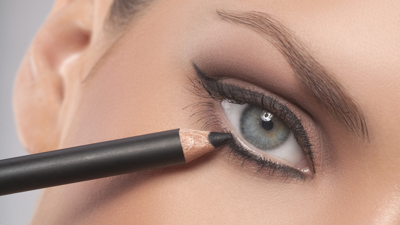 Woman applying eyeliner