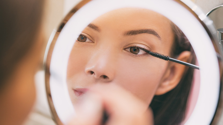 Woman applying mascara