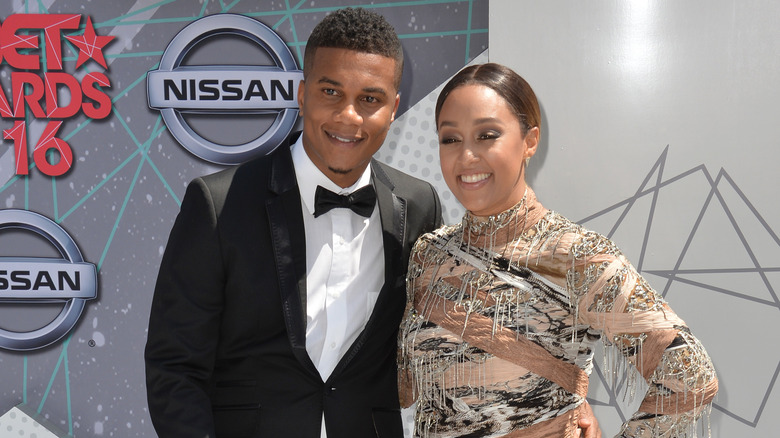 Tia Mowry and Cory Hardrict posing and smiling together