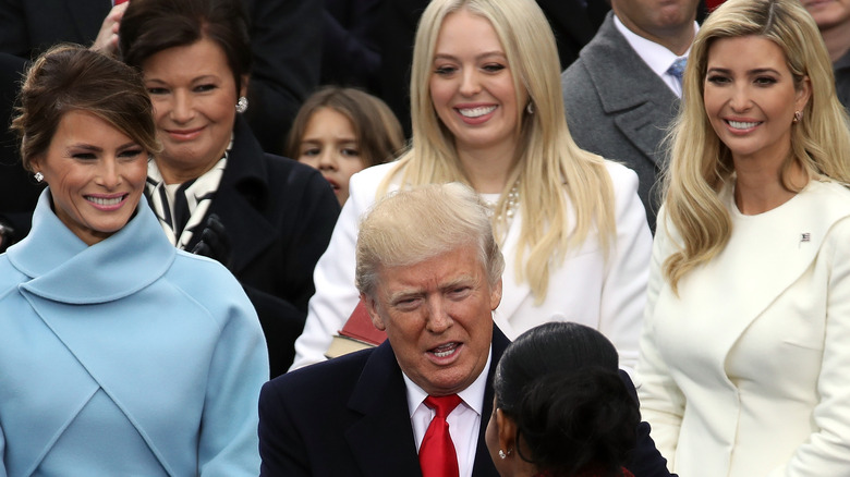 Tiffany Trump smiling behind Donald Trump