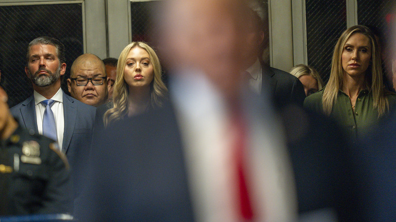 Tiffany Trump, Donald Trump Jr., and Lara Trump seen behind Donald Trump at a New York courthouse