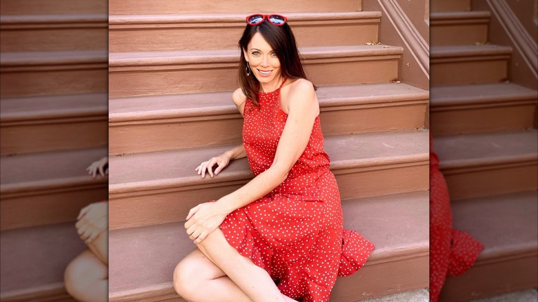 Kalika Moquin sitting on a stoop