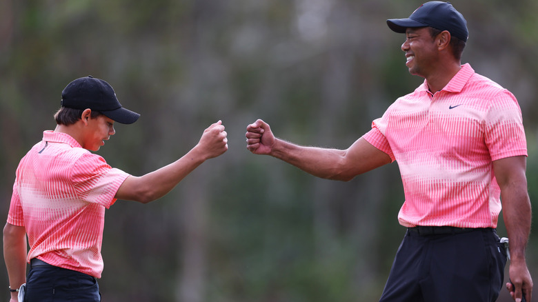 Tiger and Charlie Woods golfing