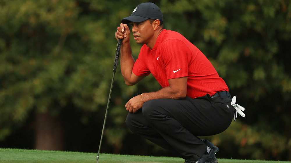 Tiger Woods crouching down