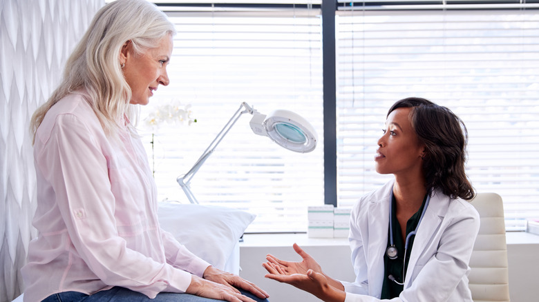 Patient and doctor having conversation in exam room