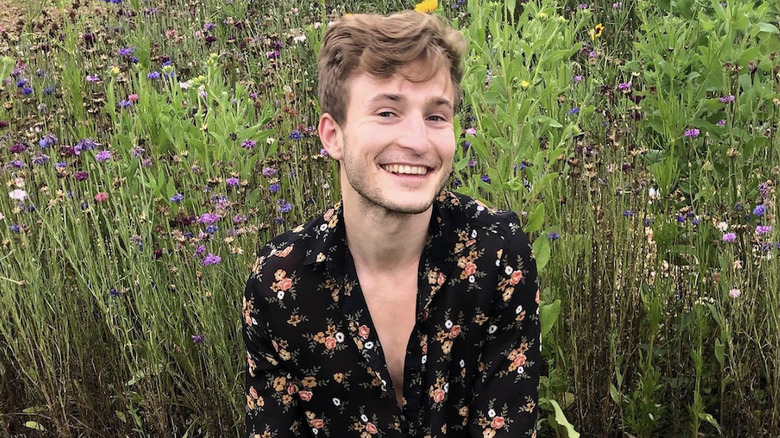 Josh Tvrdy smiling in a field