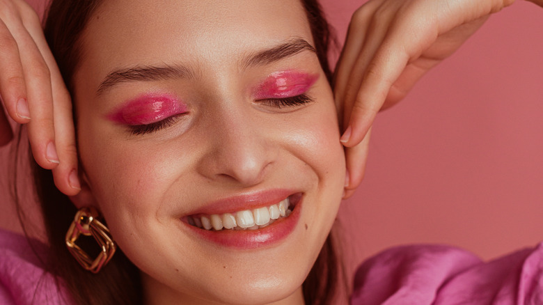 Woman with pink eyeshadow smiling