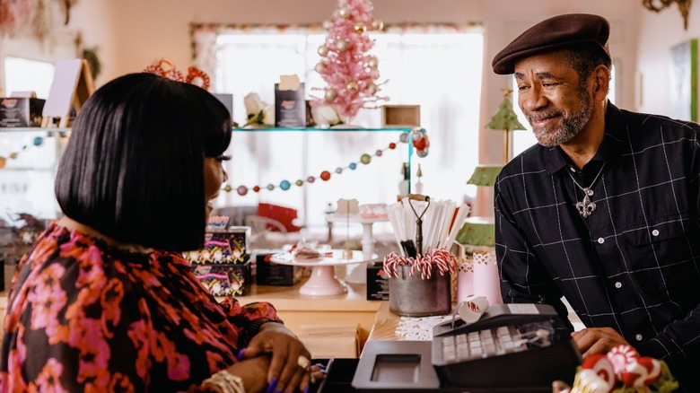 Patti LaBelle and Tim Reid talking across counter in A New Orleans Noel