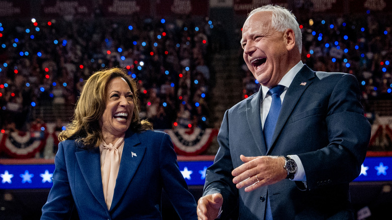 Kamala Harris and Tim Walz smiling onstage