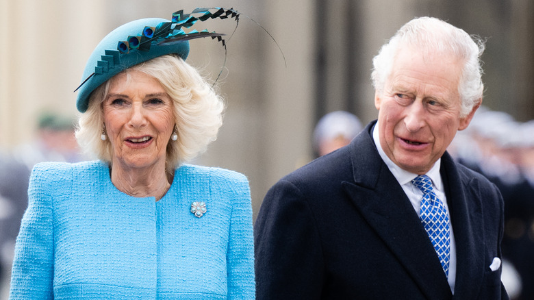 Queen Camilla and King Charles walking outside