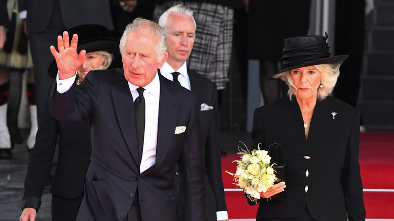 King Charles and Queen Camilla wearing black