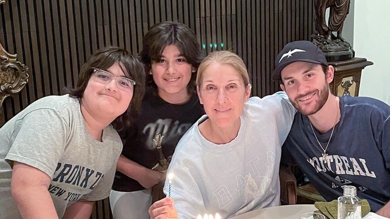 Céline Dion smiling with Eddy Angélil, Nelson Angélil, and René-Charles Angélil