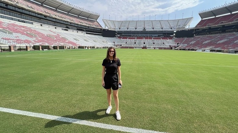 Kaitlan Collins in black t-shirt and short set at football stadium