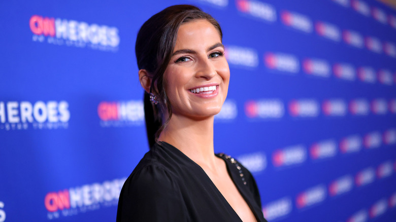 Kaitlan Collins smiling on the CNN Heroes red carpet