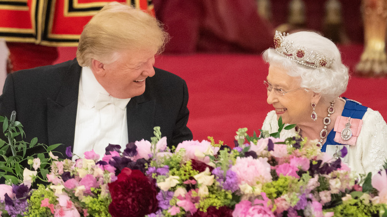 Donald Trump and Queen Elizabeth smiling at each other