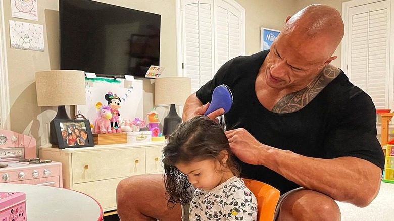 Dwayne Johnson brushes his daughter Tiana's hair (2021)