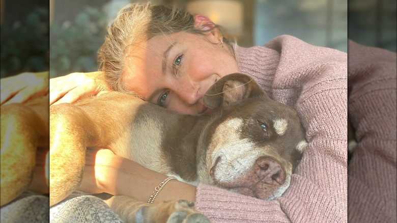 Gisele Bündchen cuddling a dog