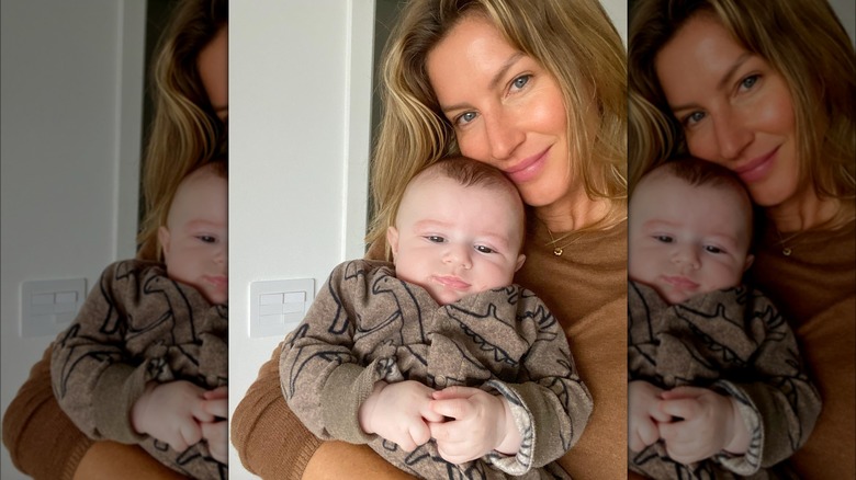 Gisele Bündchen holding a baby