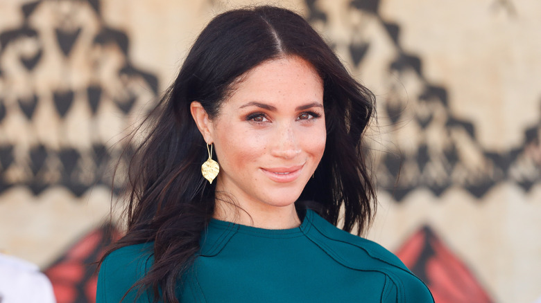 Meghan Markle smiling teal top